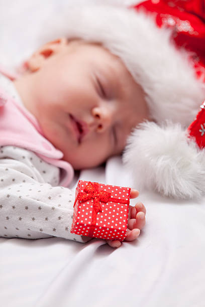 istock Little baby sleeping with christmas gifts 504341850
