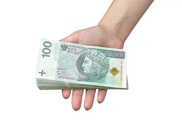 Hand taking a stack of polish zloty