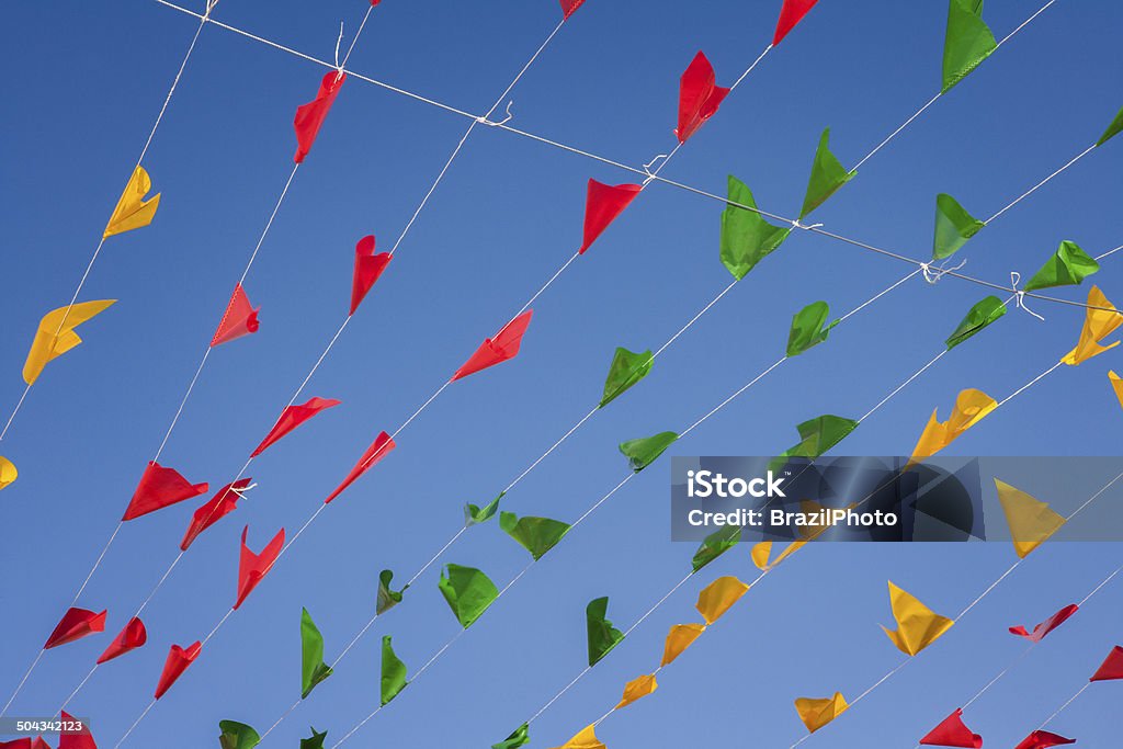 Bunting, colorful party flags, on a blue sky. Art Stock Photo