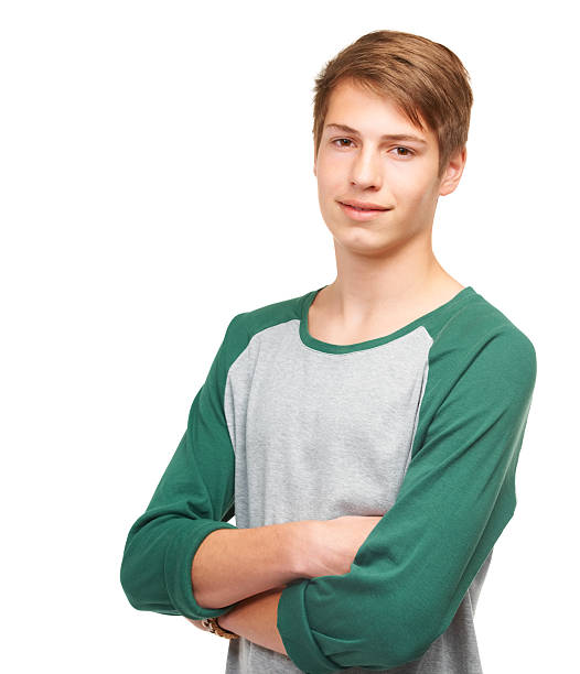 A handsome young teenager standing confidently in a studio