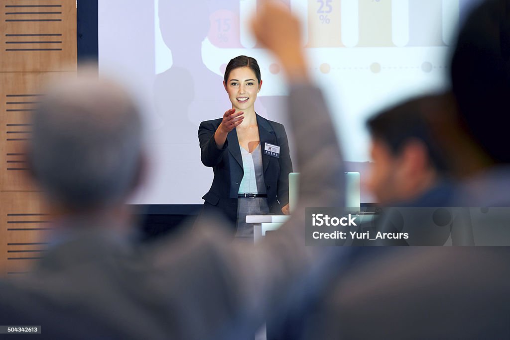 Opening the floor for questions A portrait of a businesswoman gesturing while giving a presentation at a press conference Public Speaker Stock Photo
