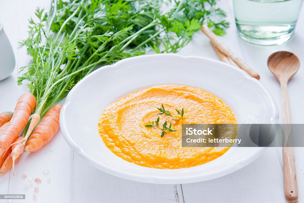 Creamy Carrot Soup Creamy Carrot Soup on white wooden background Carrot Soup Stock Photo