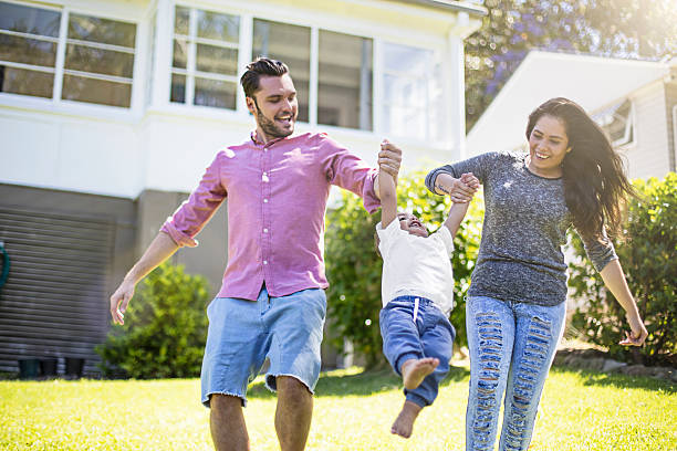 istock Couple playing with their son in garden 504343954