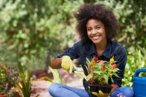 Portrait of a happy young woman doing some gardening