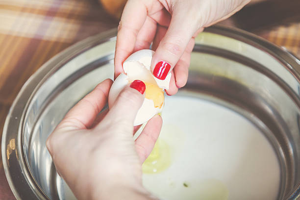 Woman hands with nice manicure share fresh egg