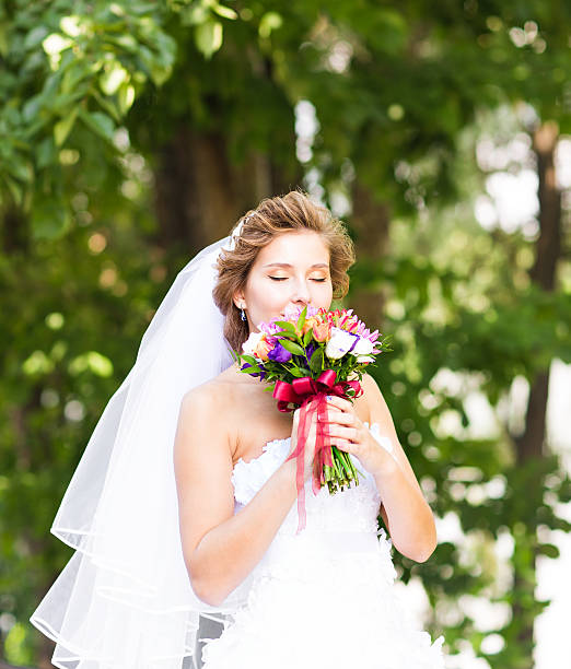 istock Beautiful bride outdoors with wedding bouquet 504344836