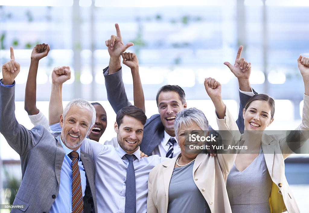 Teamwork always wins the day Cropped shot of a group of office coworkers Arm In Arm Stock Photo