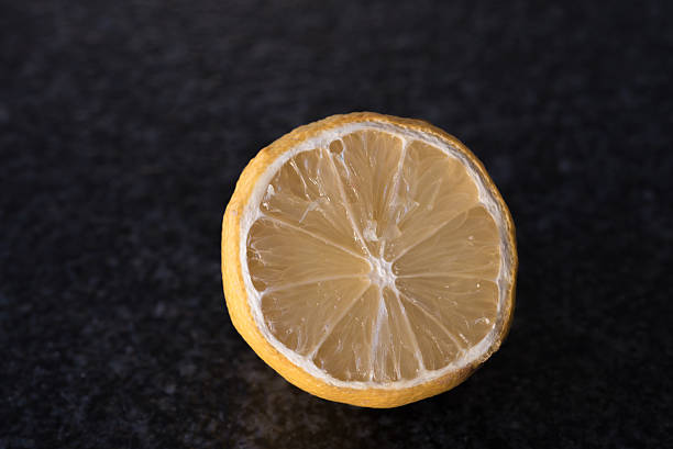 istock macro shot of a dried lemon on black background 504345040