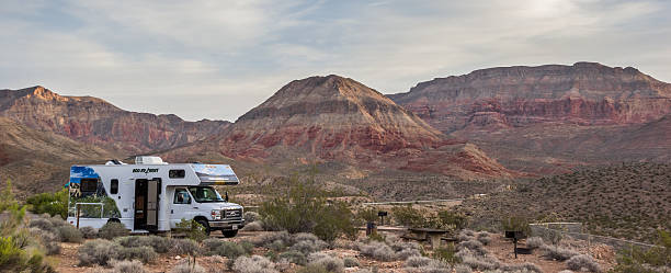 Motorhome on the Virgin River Canyon campground Virgin River Canyon, UT, USA - September 30, 2015: Motorhome on the campground of Virgin River Canyon Recreation Area. Nestled in a pocket of the spectacular Virgin River Gorge, this recreation area is surrounded by colorful cliffs and rocky canyons. virgin river stock pictures, royalty-free photos & images
