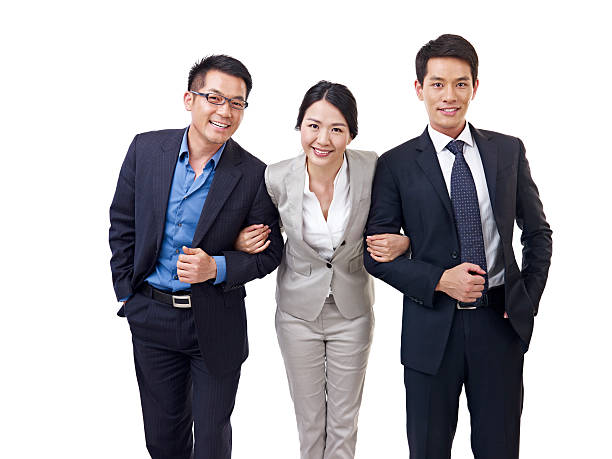 asian business team studio portrait of an asian business team. arm in arm stock pictures, royalty-free photos & images