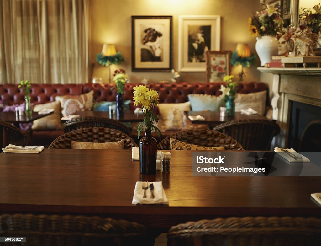 Shall we be seated? Shot of a cozy home interior with a set dining table in the foreground Dinner Stock Photo