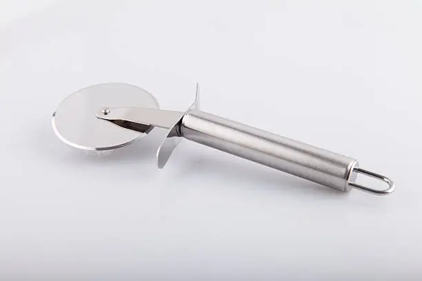Stainless Metalic Pizza Cutter - Stock Image