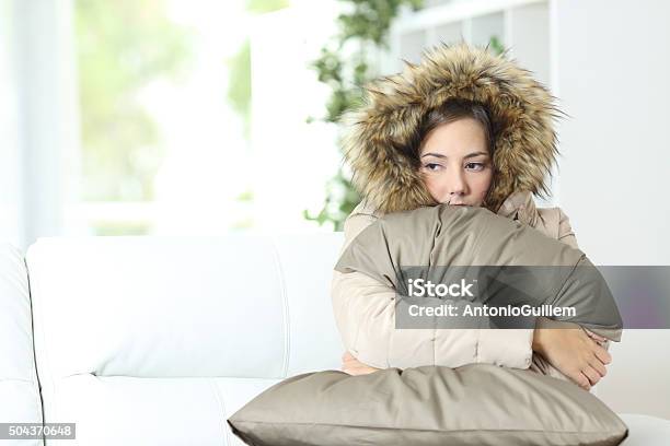 Woman Warmly Clothed In A Cold Home Stock Photo - Download Image Now - Radiator - Heater, Broken, Cold Temperature