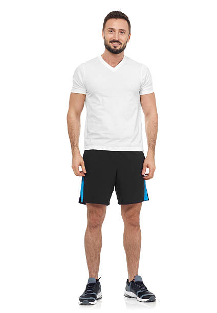 Casual man in sport clothing Cheerful man in white t-shirt looking at camera sports clothing stock pictures, royalty-free photos & images