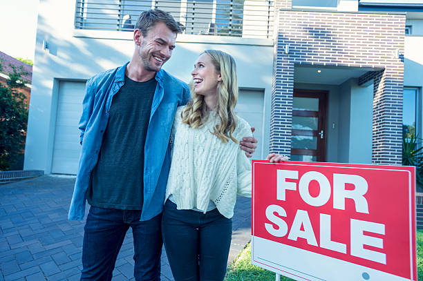 istock Couple standing in front of a new home. 504371778