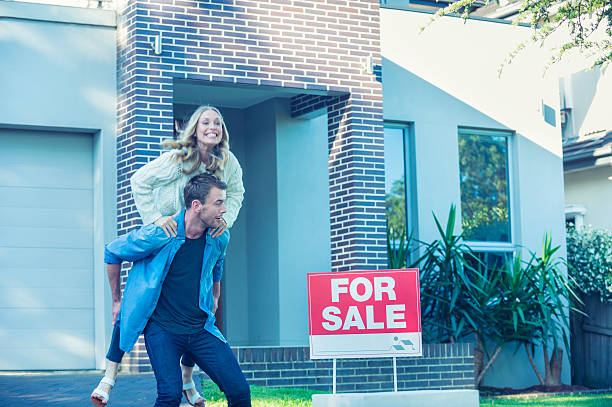 istock Couple standing in front of a new home. 504371912