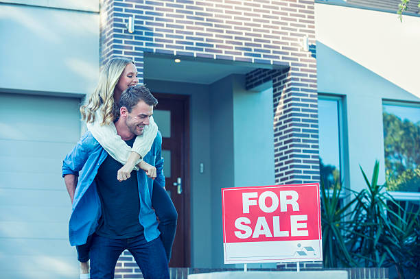 istock Couple standing in front of a new home. 504372046