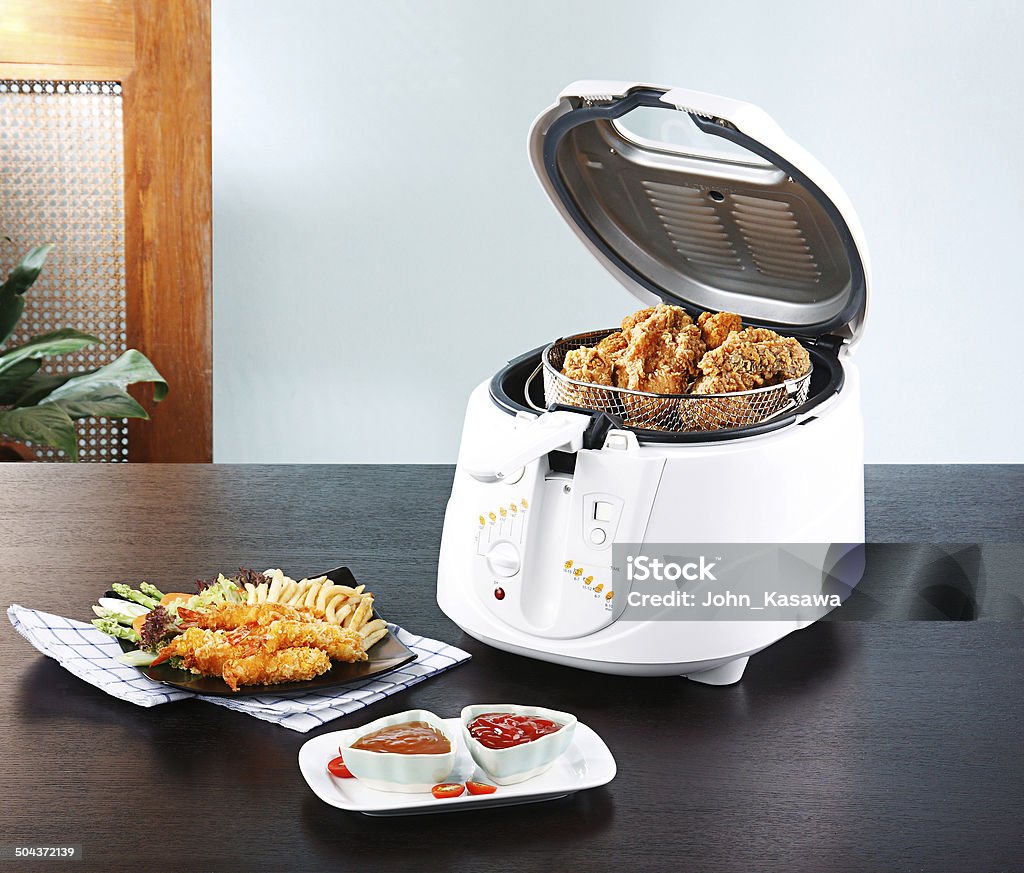 Electric fry chichen pot in the kitchen interior Appliance Stock Photo