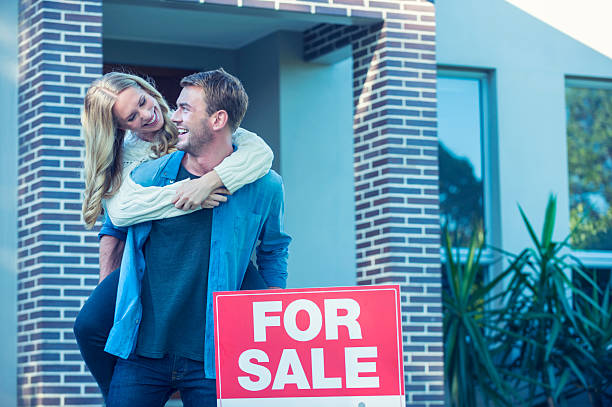 istock Couple standing in front of a new home. 504372192