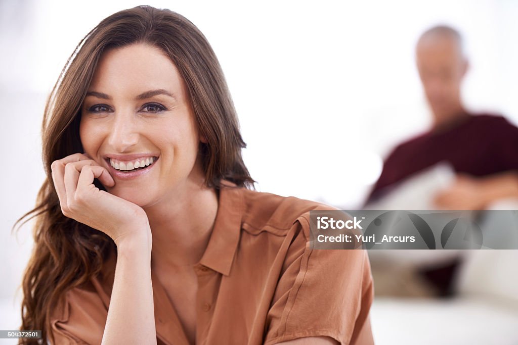 My husband has an awesome wife Shot of a smiling young woman and her mature husband reading the newspaper at home 30-39 Years Stock Photo