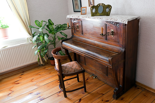 antique piano with two candles in the interior
