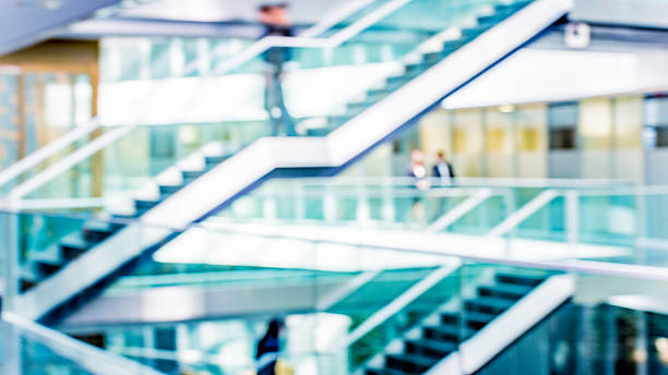 istock Businesspeople walking in office corridor, defocused 504374388