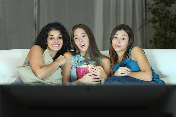 istock Three friends watching romantic movie on tv 504374784