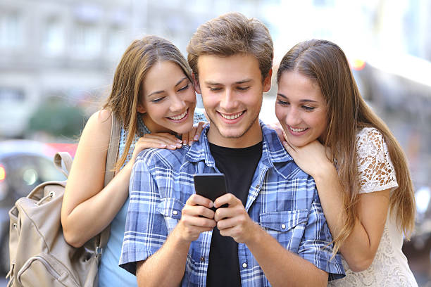 istock Friends sharing media in a smart phone 504375216