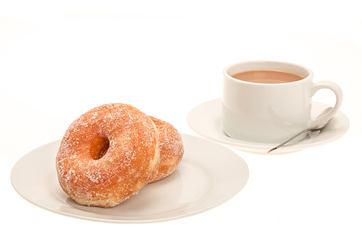 Two sugar coated ring donuts with a hot drink - studio shot with a white background
