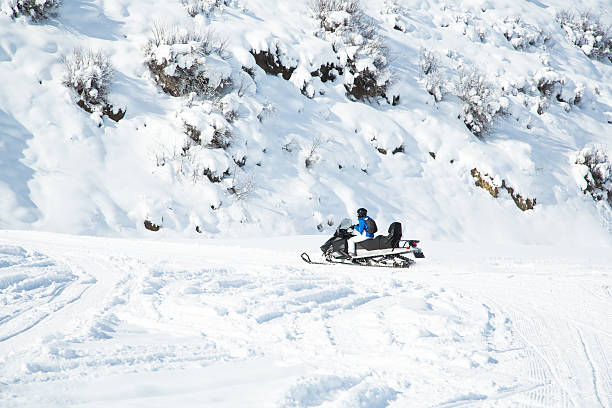 istock Woman driving a snowmobile 504376060