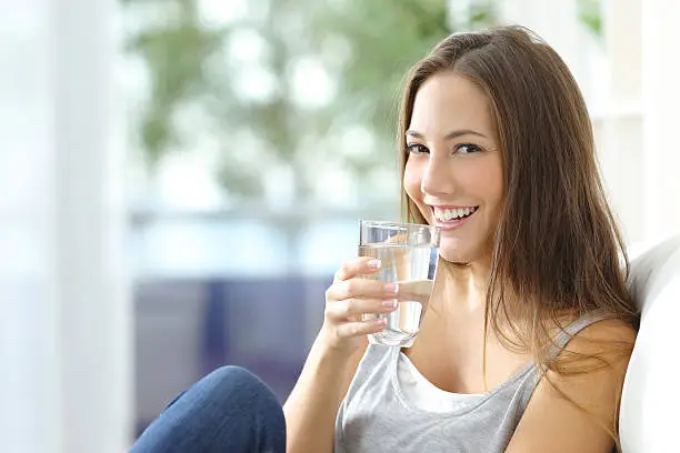Photo of Girl drinking water at home