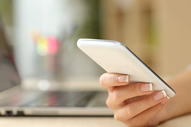 istock Woman hand using a white smart phone 504377272