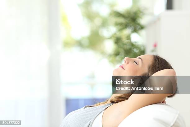 Woman Relaxing Lying On A Couch At Home Stock Photo - Download Image Now - Freshness, Wind, Breathing Exercise