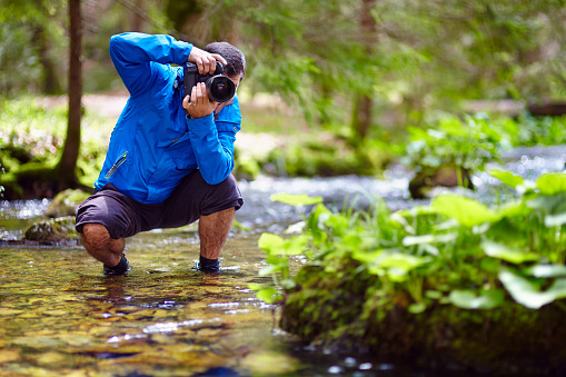 Professional nature photographer taking photos by the river side