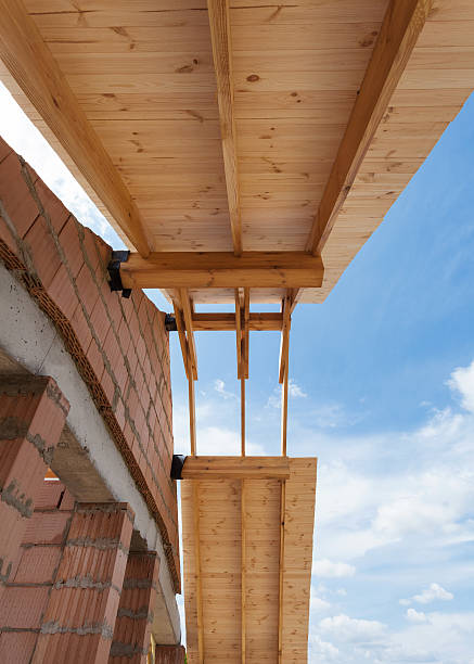 istock New house under construction. Building a roof against blue sky 504378044