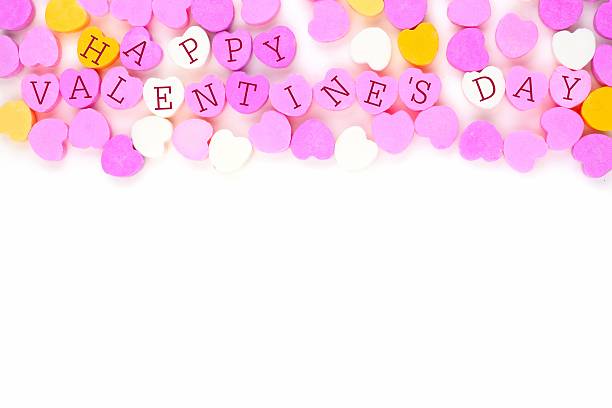 istock Happy Valentines Day candy hearts top border over white 504378930
