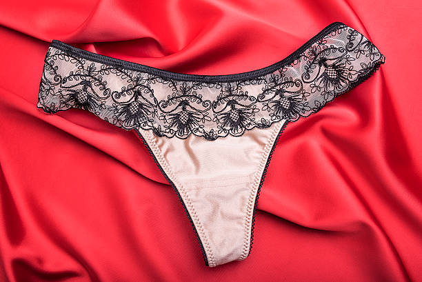 istock Women's panties on red satin 504378968