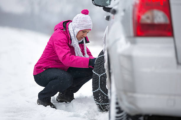 istock Woman  installing tire chain 504379110