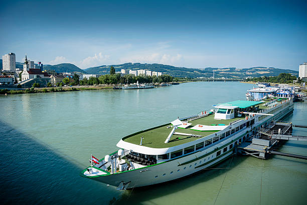 Scene on a sunny day in Upper Austria with cruise liners docked on the Danube