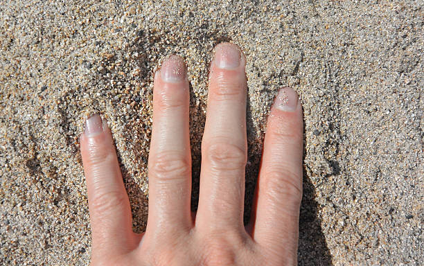 istock Caucasian hand in the sand 504379788