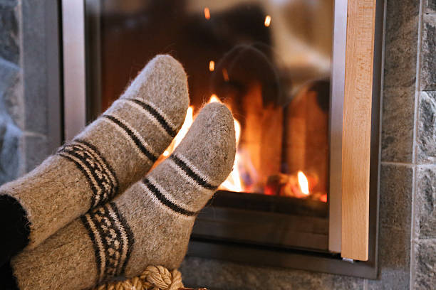 istock Feet in wool socks warming at the fireplace 504380504