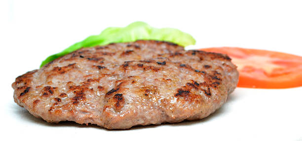 istock hamburger and some vegetables on a white background 504380856