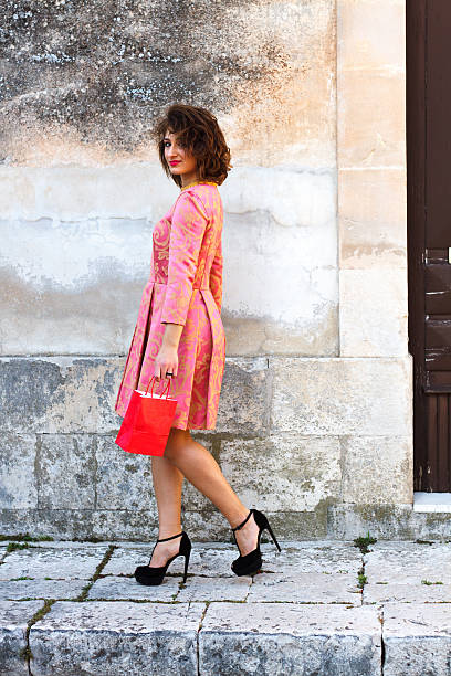 istock Chic Young European Beauty with Red Shopping Bag 504383714