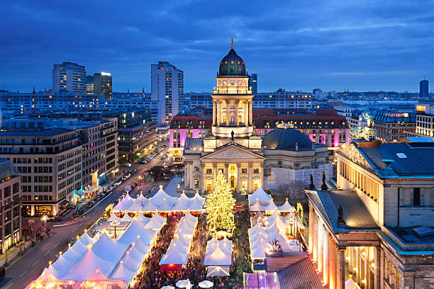 Aerial view onto Christmas market at Gendarmenmarkt square in Berlin Dusk view on a Christmas market at the end of December, taken from the top of the French Cathedral east berlin photos stock pictures, royalty-free photos & images
