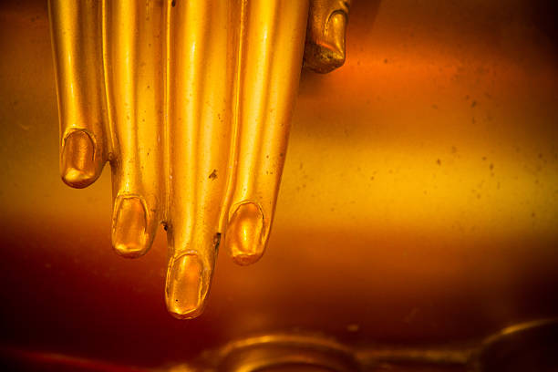 istock Fingers of a golden statue. 504385812