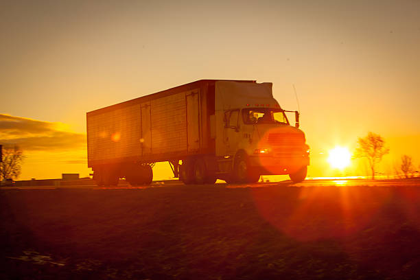 istock Tractor trailer hauling a load at dawn. 504386682