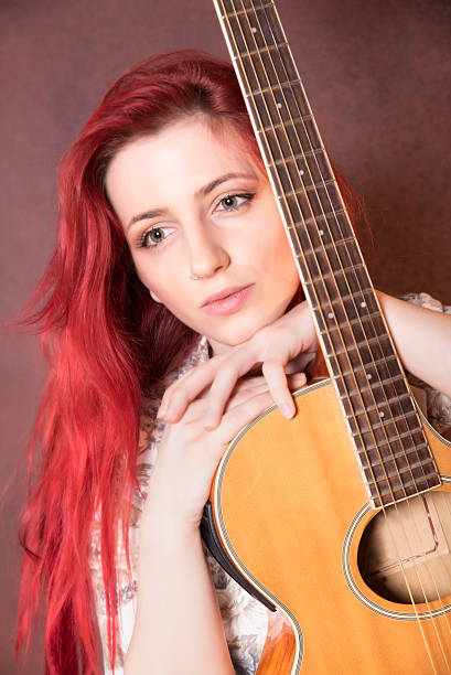 istock red-haired girl with a guitar 504386796