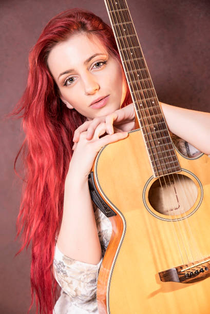 istock red-haired girl with a guitar 504386902