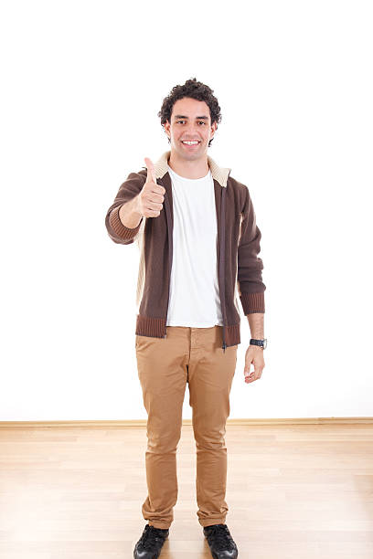 istock full length young casual man showing thumbs up 504397665