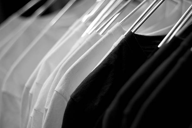 White t-shirts on cloth hangers in row
